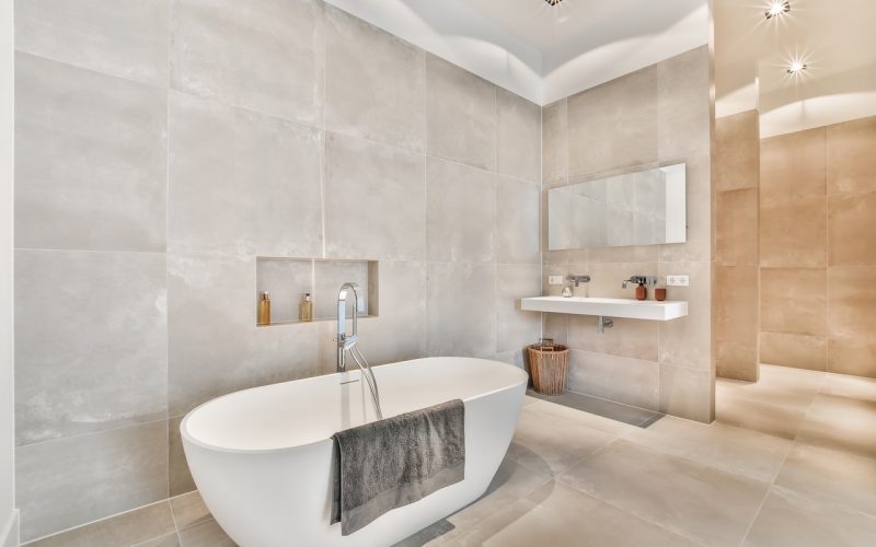 Beautiful bathroom with a big bathtub and white big windows