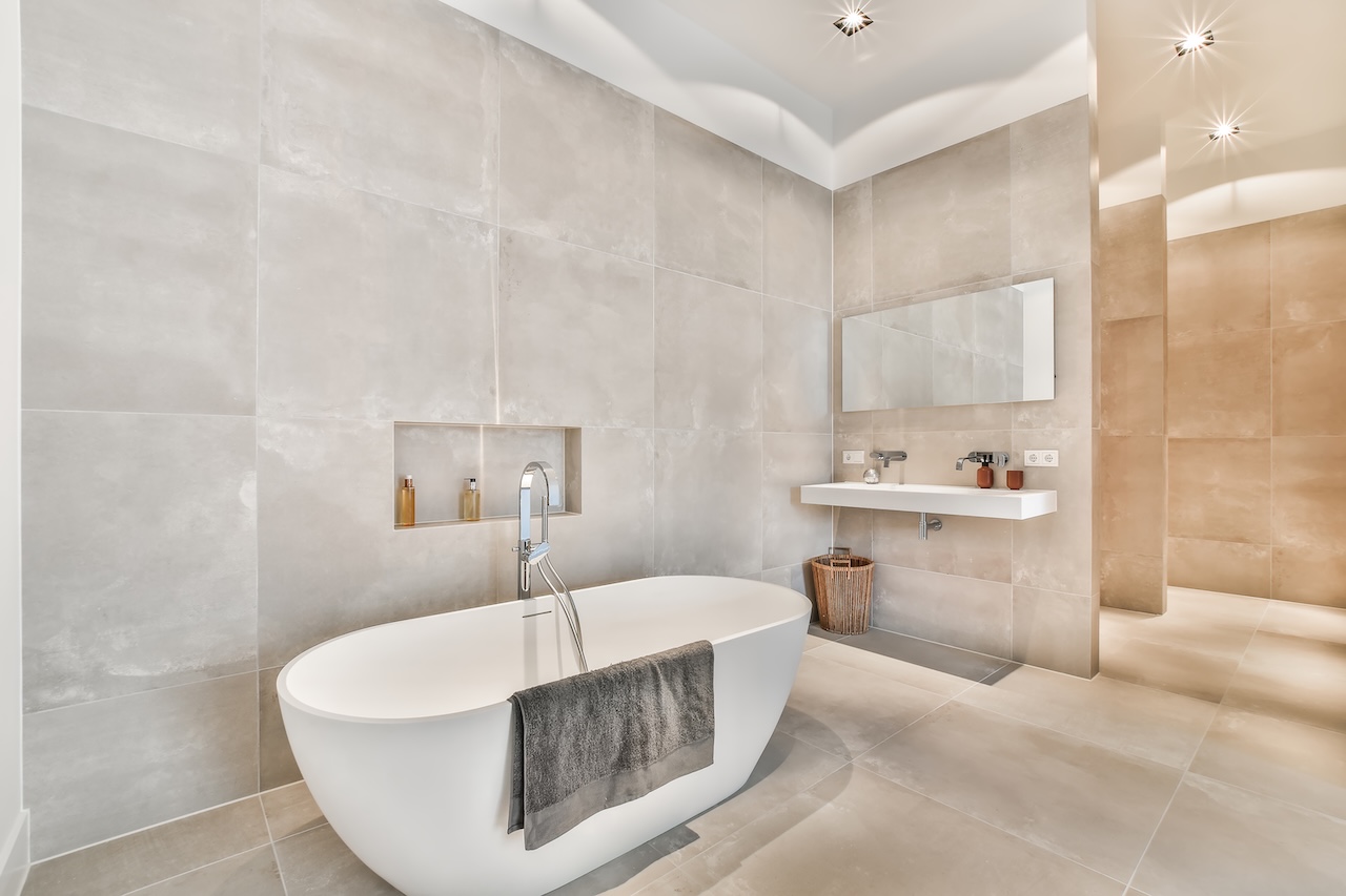 Beautiful bathroom with a big bathtub and white big windows